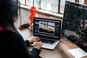 woman editing images on laptop